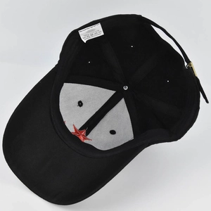 Detail view of cotton baseball cap interior showing care label and embroidery quality