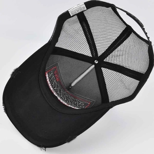 Detail view of trucker hat mesh back and interior label showing cotton polyester blend