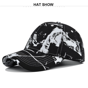 Detail of black and white tie-dye graffiti baseball cap with artistic side lettering