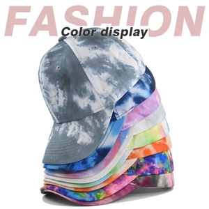 Collection of tie-dye cotton baseball caps in various colors with a fashion display