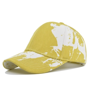 Detail of tie-dye mustard yellow and white cotton baseball cap with curved brim and stitching