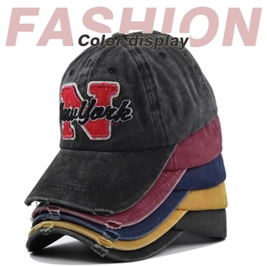 Detailed vertical stack of vintage washed cotton NY embroidered baseball caps in many colors