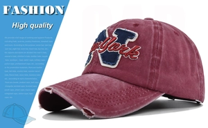 Detail of vintage burgundy cotton baseball cap with New York 3D embroidery and distressed brim