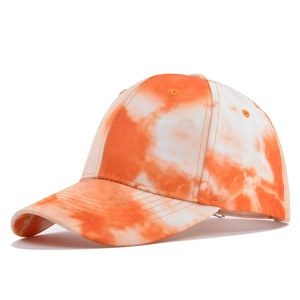Close-up of vibrant orange and white tie-dye cotton baseball cap with curved brim