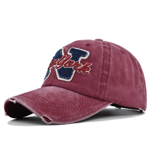 Detailed view of burgundy vintage distressed cotton baseball cap with New York embroidery