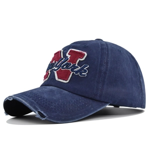 Close-up of distressed brim detail on a vintage washed cotton New York baseball cap