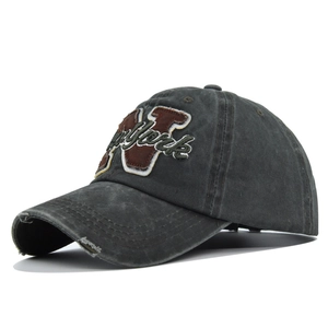 Detailed embroidery of New York text and N patch on distressed vintage dark grey cap