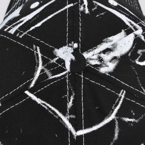 Close-up detail of a black cotton baseball cap showing top button and reinforced stitching