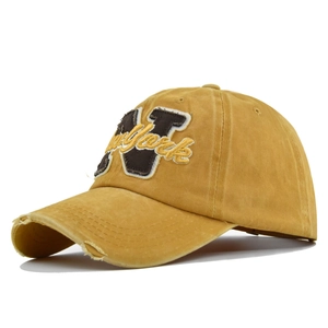 Detail of vintage washed mustard yellow baseball cap with N and New York embroidery