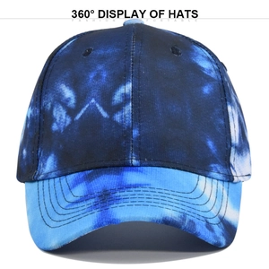 Close-up of blue tie-dye baseball cap featuring detailed stitching and six-panel crown