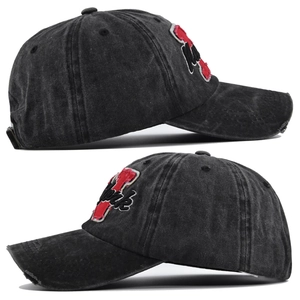 Close-up of vintage washed denim baseball cap with distressed brim and 3D New York embroidery