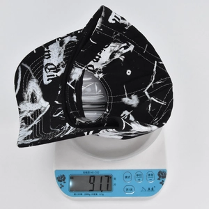 Tie-dye baseball cap weighing 91.7g on an electronic scale showing product density