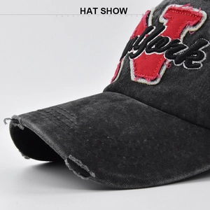 Detailed close-up of vintage distressed black canvas hat with New York 3D embroidery