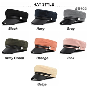 Detail view of retro newsboy caps in seven colors featuring metal buttons and PU leather brims