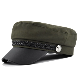 Detail of olive green navy hat with black braided rope and silver embossed metal button