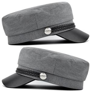 Detail of vintage mariner cap with grey fabric, leather visor and silver buttons