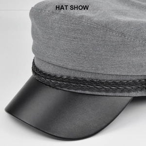 Detail view of the vintage grey fabric sailor hat with black leather brim and rope trim