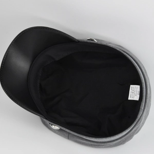 Detail view of the grey baker boy cap showing the inner lining and size 58 material label