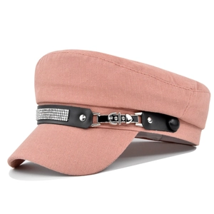 Detailed macro view of pink newsboy cap featuring rhinestone buckle and leather strap