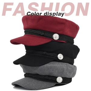 Close-up of wool sailor caps in burgundy black and grey with silver anchor buttons