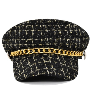 Classic black tweed baker boy hat with golden chain detail and vintage plaid texture
