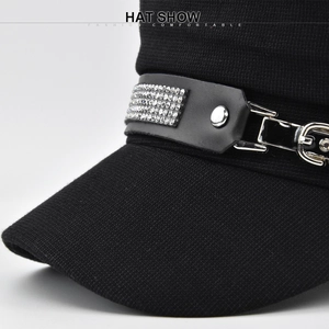 Detail of black knit navy cap featuring leather band with rows of sparkling rhinestones