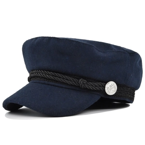 Detail of silver anchor button and braided rope on navy blue wool blend captain hat