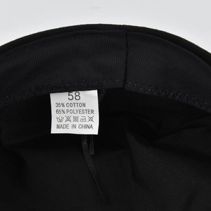 Detail view of inner sweatband and material label of the black cotton polyester beret