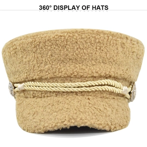 Detail view of khaki teddy fleece baker boy hat with braided rope and metal buttons