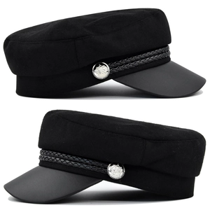 Detail of black wool fiddler cap with leather brim, braided rope and metal side button