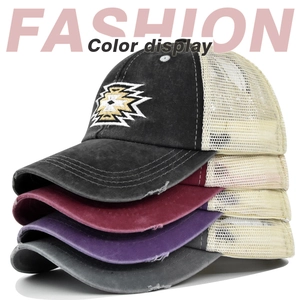 Detailed stack of multi-color distressed cotton baseball caps with tribal geometric embroidery