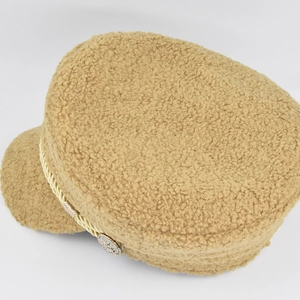 Detail view of camel lambswool newsboy hat with golden braided rope and metal button detail