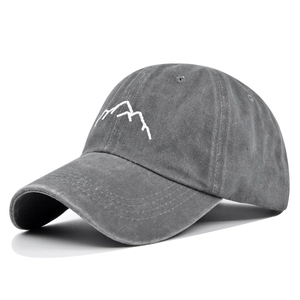 Close-up of white mountain embroidery on washed gray cotton canvas baseball cap