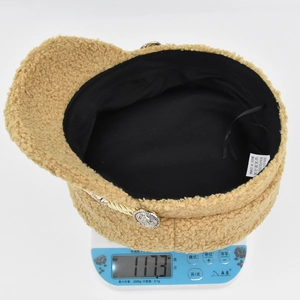 Detail showing 117.3g lightweight camel fleece newsboy hat with textured wool fabric