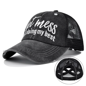 Detail showing cross elastic bands on a distressed mesh ponytail baseball cap