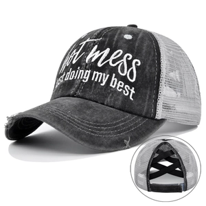 Detail of distressed baseball cap with high ponytail criss cross bands and mesh back