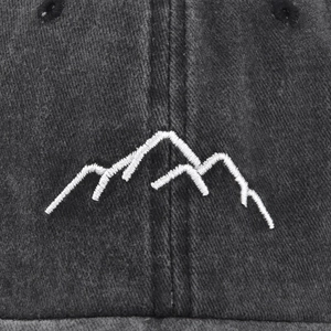 Vintage black washed baseball cap with white mountain embroidery detail and twill texture