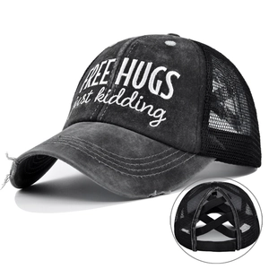 Detail of cross elastic bands for ponytail on washed canvas mesh trucker baseball cap