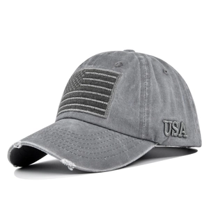 Macro detail of 3D USA embroidery and distressed edges on washed grey cotton baseball cap