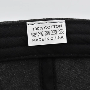 Macro detail of the 100% cotton wash care label and stitching on a baseball cap