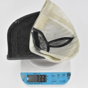 Detailed top view of embroidered ponytail baseball cap weighing 73.3g on a scale