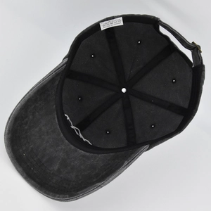 Detailed interior of the cotton baseball cap showing reinforced seams and adjustable metal buckle