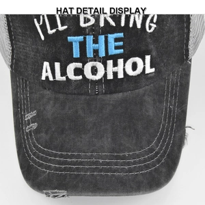 Detail view of washed canvas trucker hat with 3D embroidery and distressed brim texture