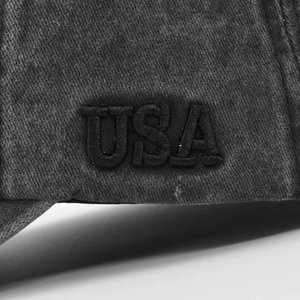 Macro shot of 3D USA embroidery on washed charcoal twill cotton baseball cap