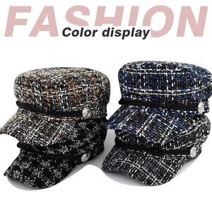 Detail of tweed sailor caps with braided cords and vintage metallic side buttons