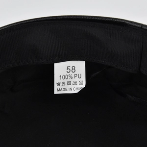 Detail of internal lining and 100% PU material label for the black Baker Boy cap