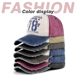Detailed stack of vintage washed baseball caps showing distressed brims and graffiti prints