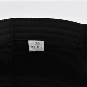 Detail of internal reinforced stitching and 100% cotton label on black flat top cap