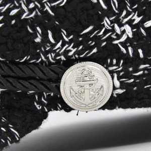 Women's tweed baker boy hat featuring a silver anchor button and black braided cord detail