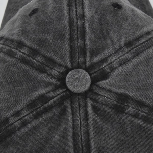 Close-up of washed charcoal baseball cap crown with vintage stitching and eyelet detail